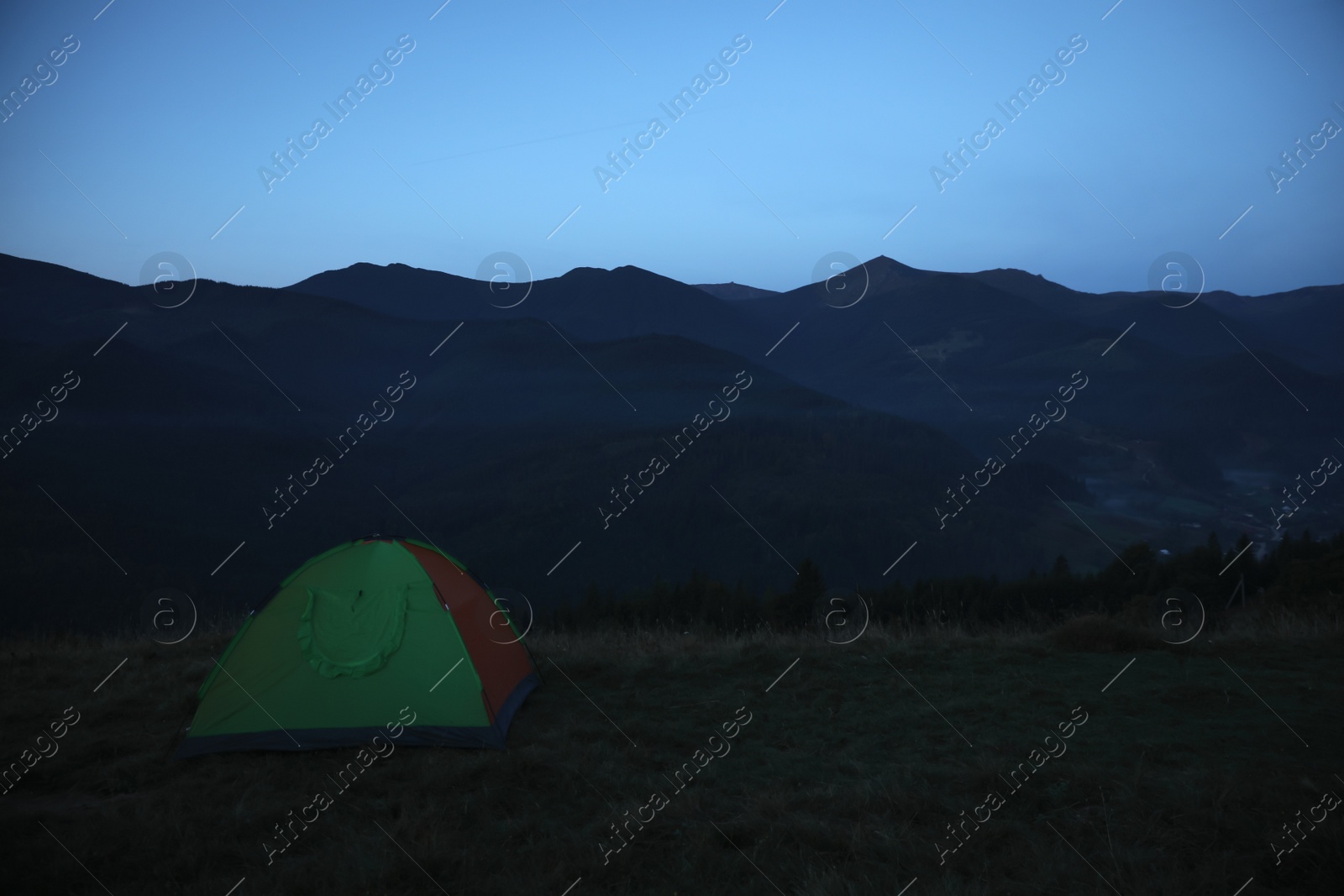 Photo of Camping tent on mountain slope in morning