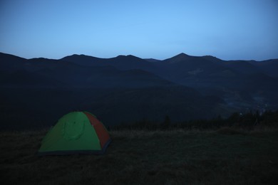 Photo of Camping tent on mountain slope in morning