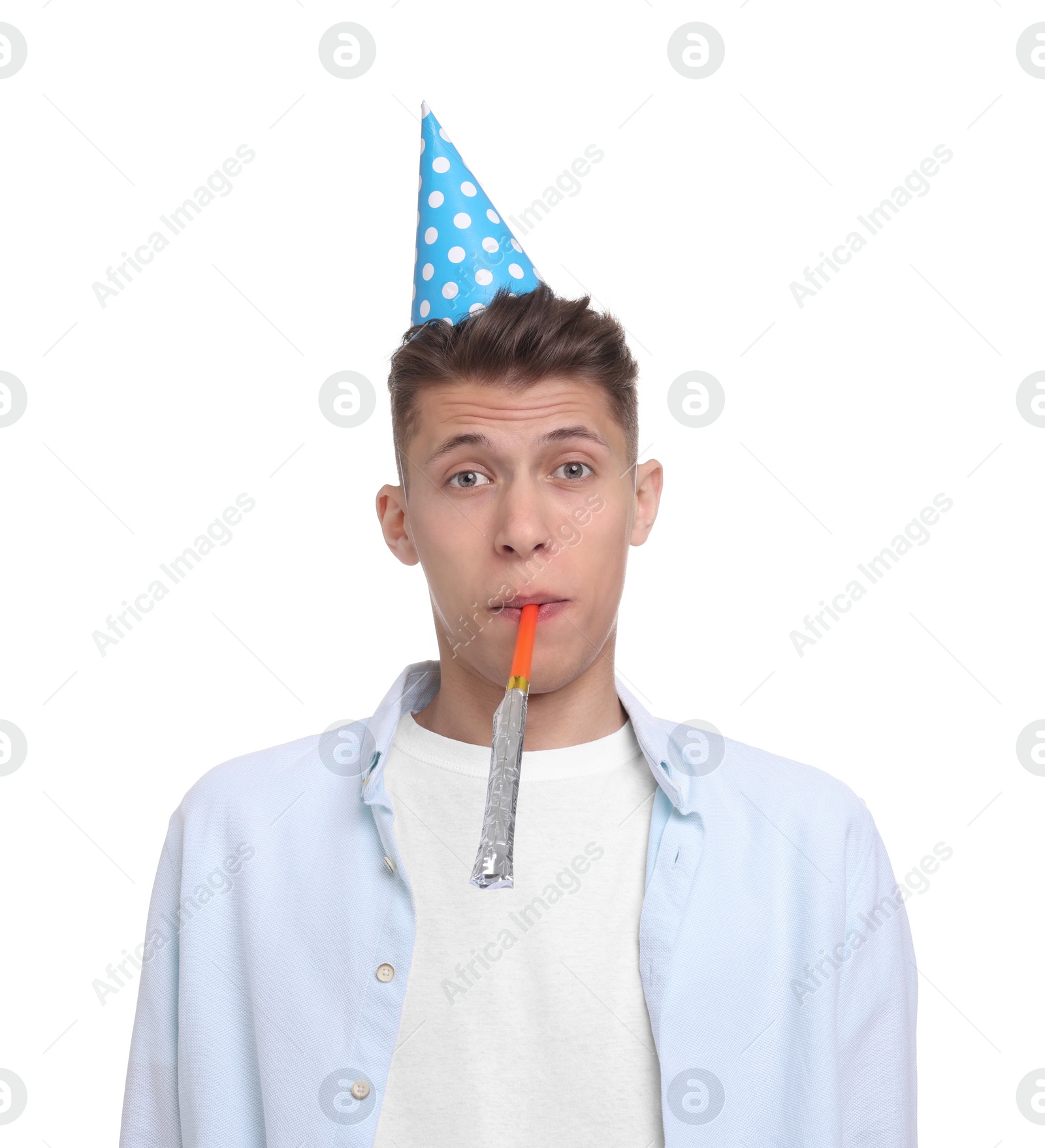 Photo of Young man in party hat with blower on white background