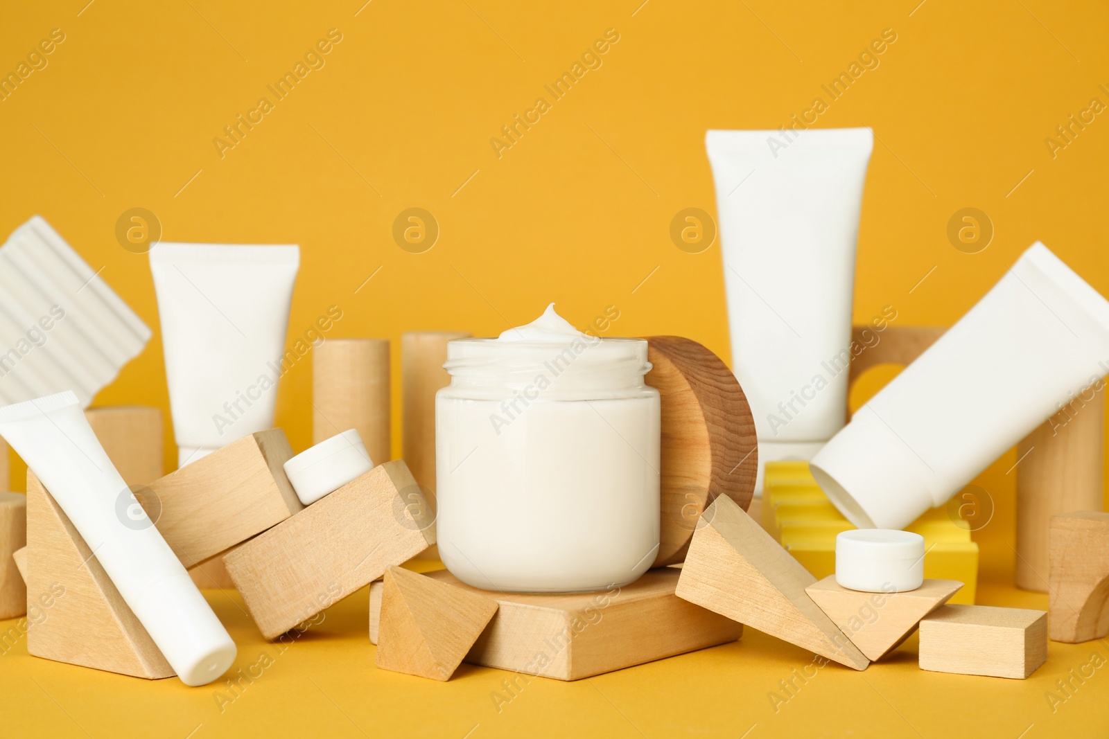 Photo of Composition with different cosmetic products on orange background