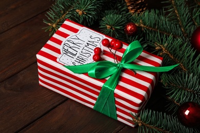 Christmas composition with gift box and festive decor on wooden table