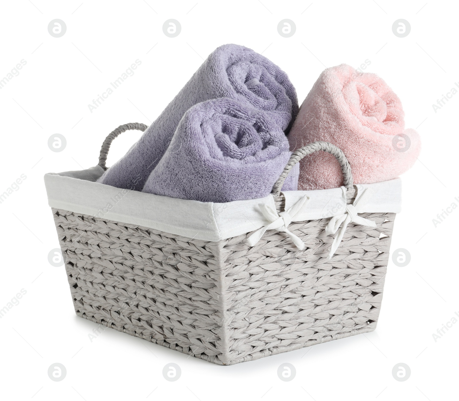 Photo of Basket with rolled towels isolated on white