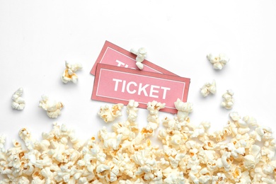 Photo of Popcorn and tickets on white background, top view. Cinema snack