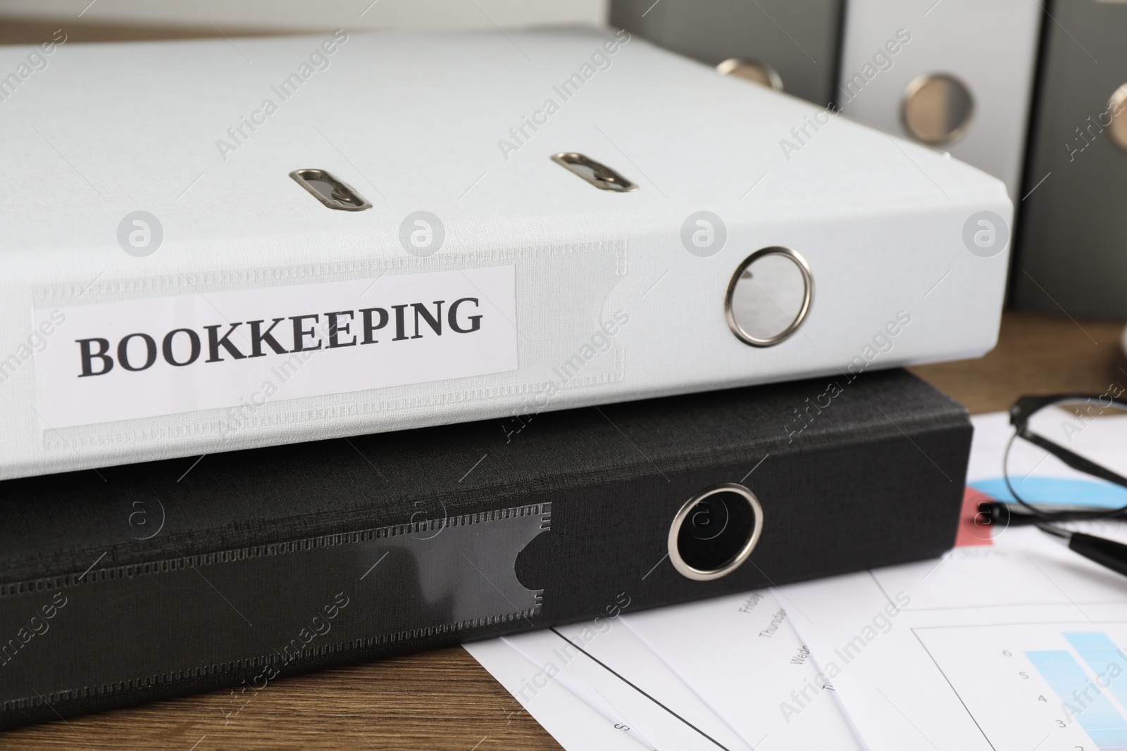 Photo of Folders and documents on desk in office, closeup. Bookkeeper's workplace