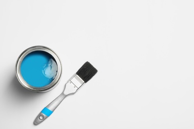 Paint can and brush on white background, top view. Space for text