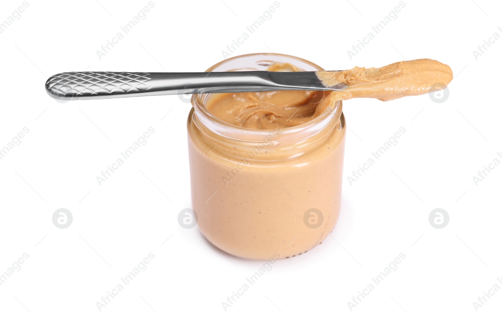 Photo of Tasty nut paste in jar and knife isolated on white