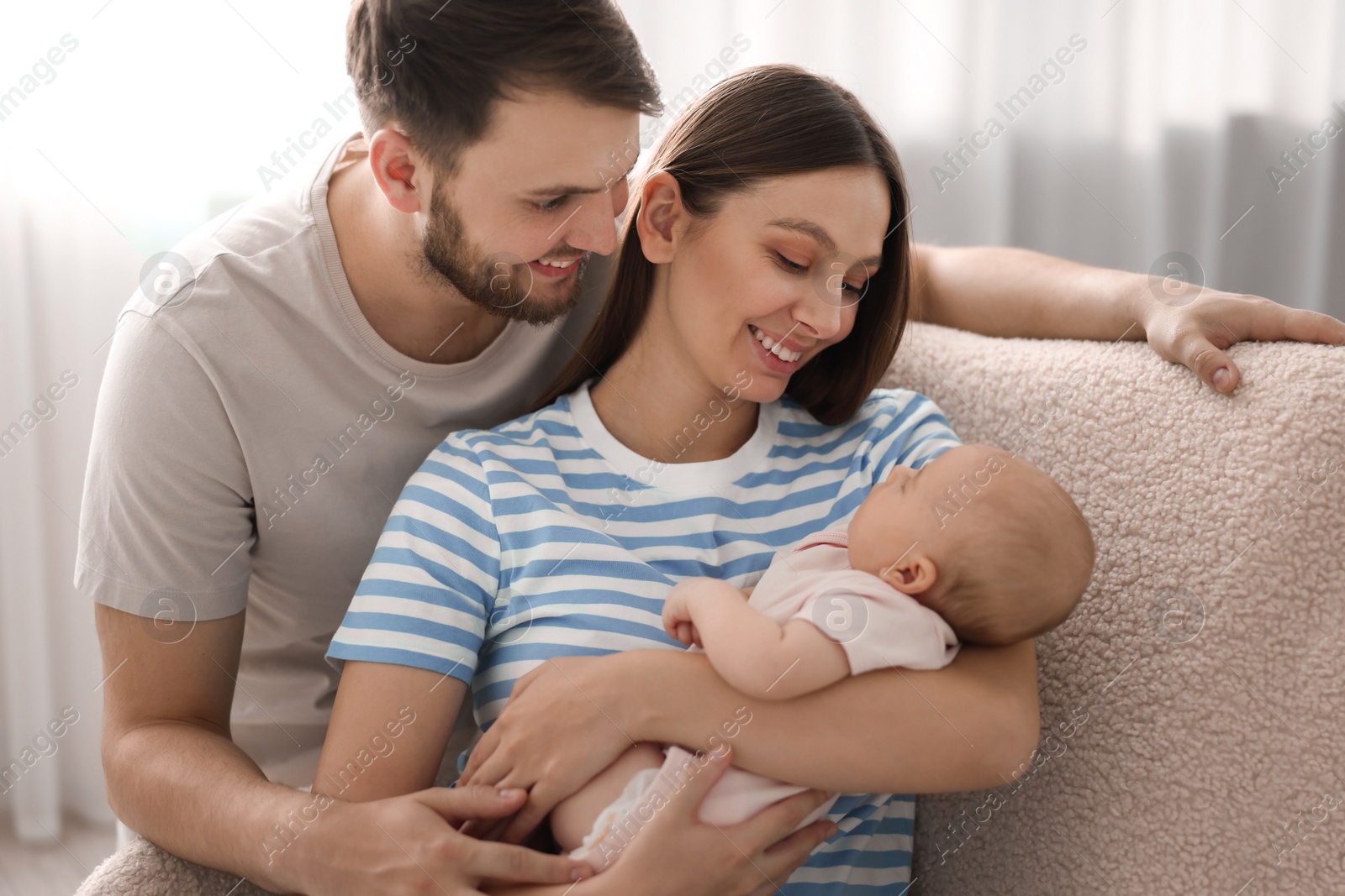 Photo of Happy family. Parents with their cute baby at home