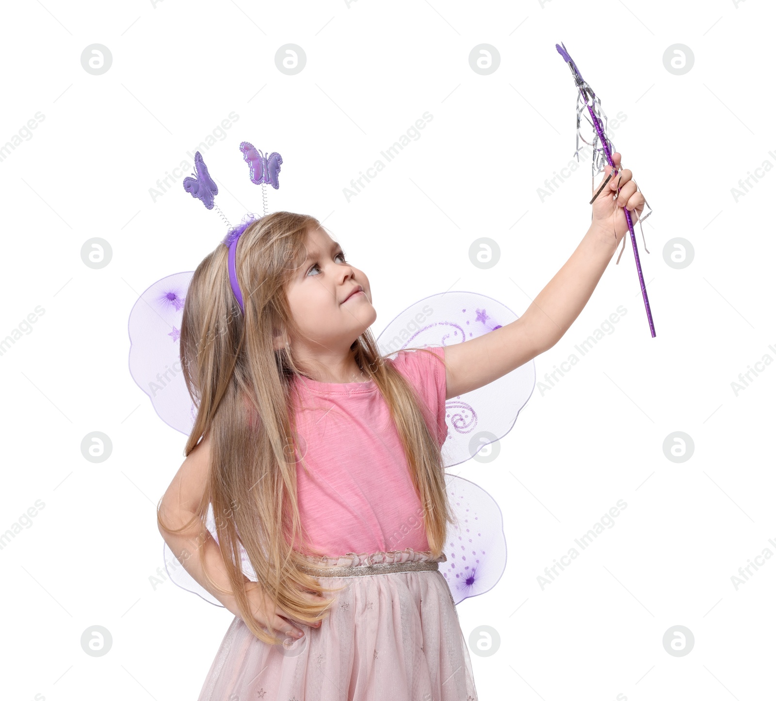 Photo of Cute little girl in fairy costume with violet wings and magic wand on white background