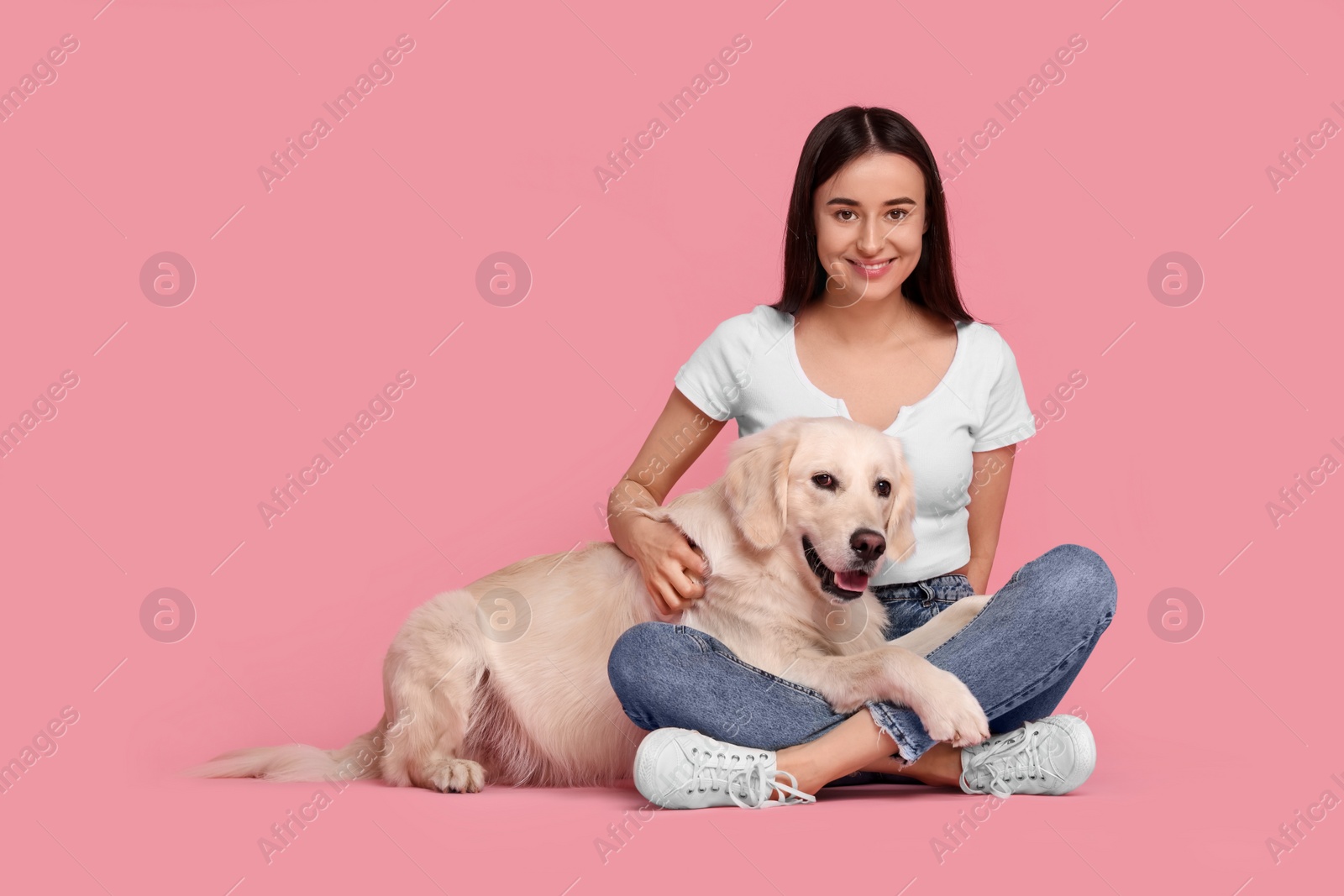 Photo of Happy woman with cute Labrador Retriever dog on pink background, space for text. Adorable pet