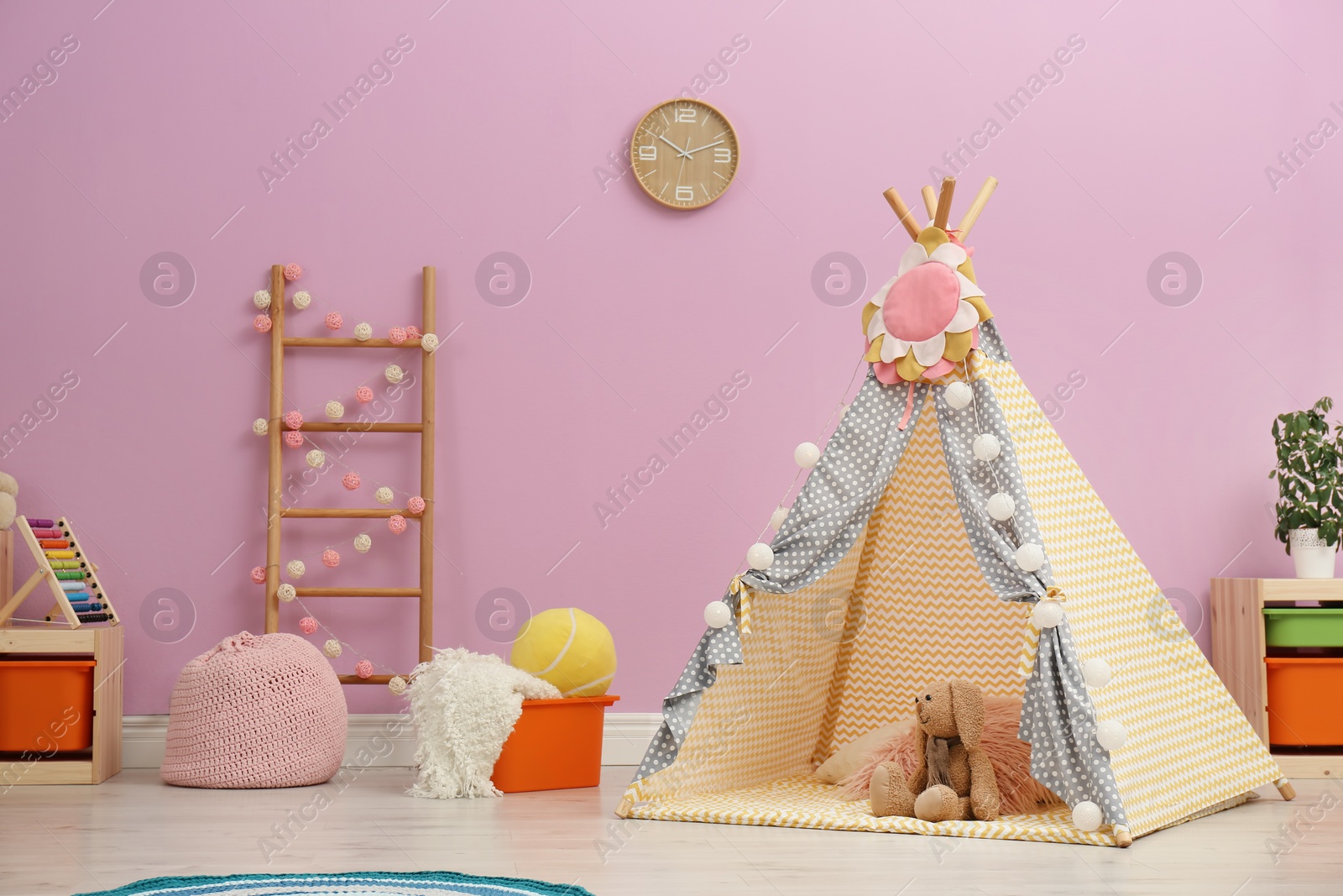 Photo of Modern nursery room interior with play tent for kids