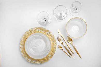 Elegant table setting on light background, top view