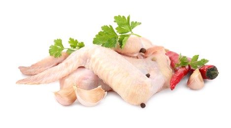 Photo of Raw chicken wings with spices and parsley on white background