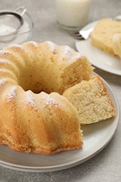 Photo of Delicious freshly baked sponge cake on gray table, closeup