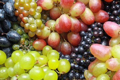 Photo of Fresh ripe juicy grapes with water drops as background, closeup