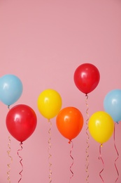 Photo of Bright balloons on color background. Celebration time