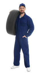 Full length portrait of professional auto mechanic with tire on white background