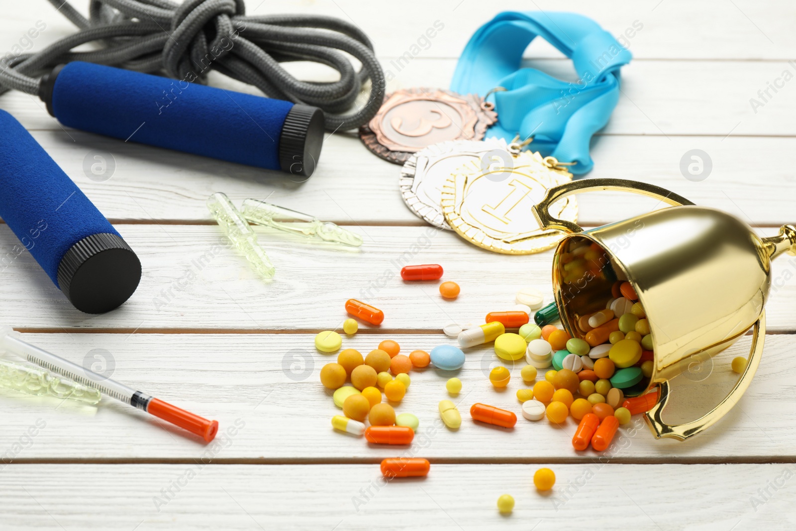 Photo of Composition with drugs on white wooden table. Doping control