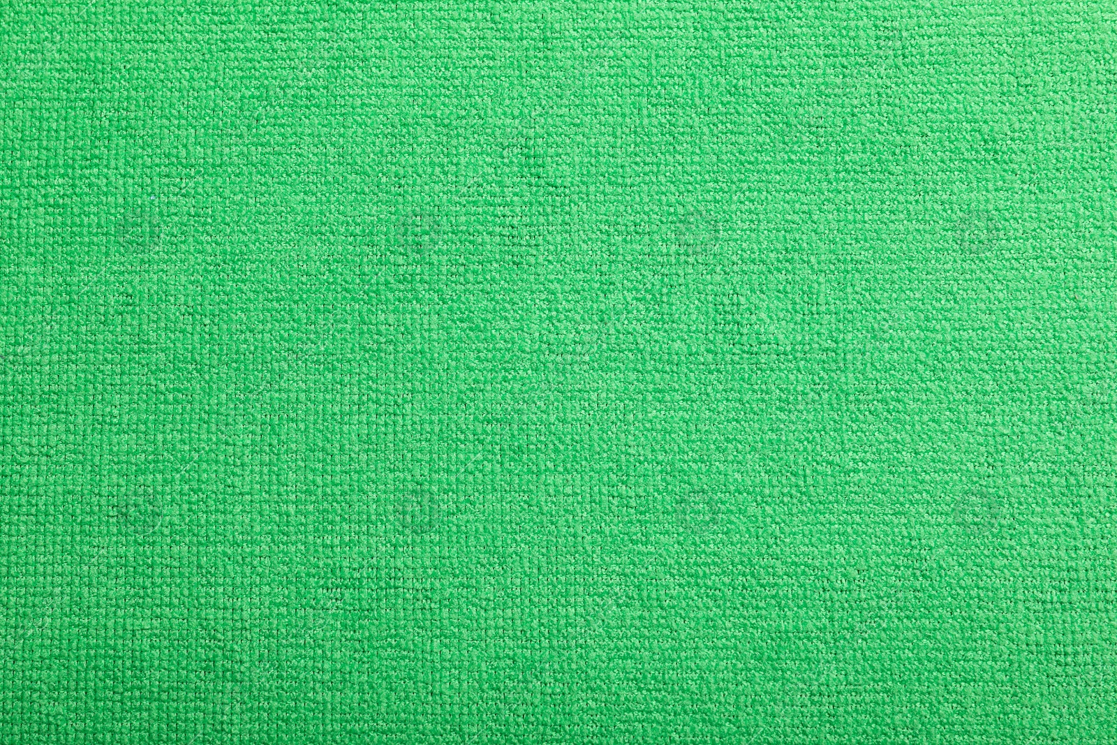 Photo of Light green microfiber cloth as background, top view