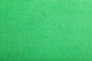 Light green microfiber cloth as background, top view