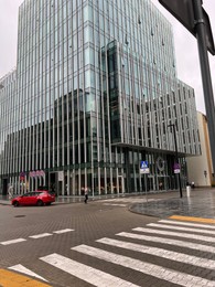 Photo of WARSAW, POLAND - JULY 11, 2022: Beautiful view of modern building and cars on city street