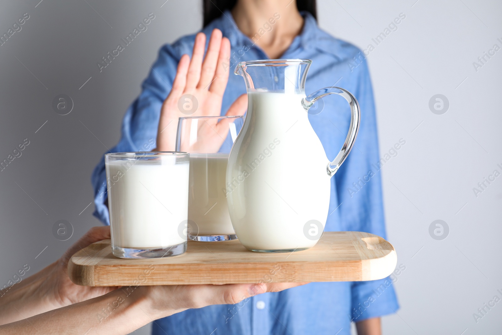 Photo of Woman refusing to drink milk, closeup. Food allergy concept