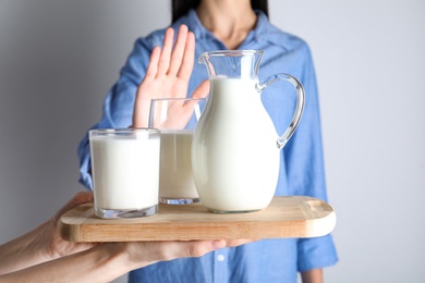 Woman refusing to drink milk, closeup. Food allergy concept