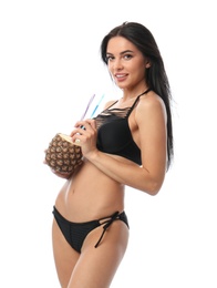 Beautiful young woman in black bikini with cocktail on white background