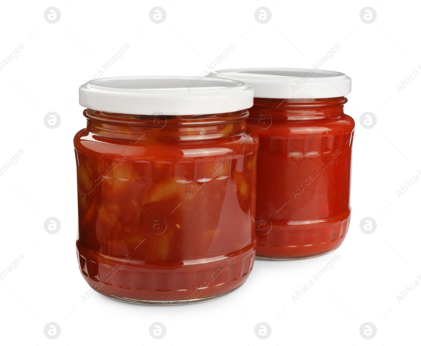 Photo of Glass jars of delicious canned lecho on white background