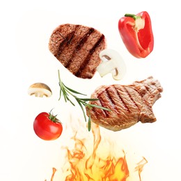 Tasty grilled meat, different vegetables and fire flame on white background