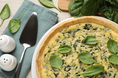 Photo of Delicious homemade spinach pie served on white wooden table, flat lay