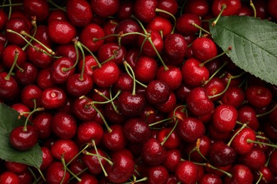 Photo of Many sweet cherries with water drops as background, top view