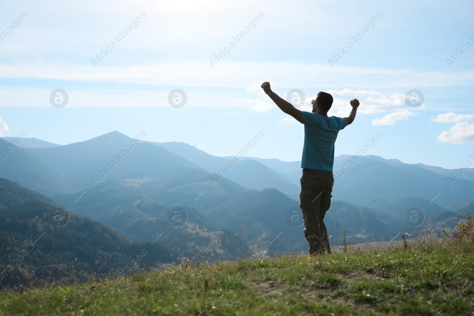 Photo of Happy tourist in mountains on sunny day