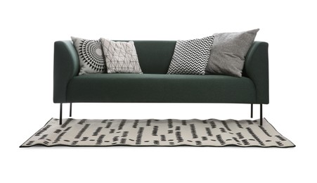 Comfortable green sofa with cushions and carpet on white background. Furniture for living room interior