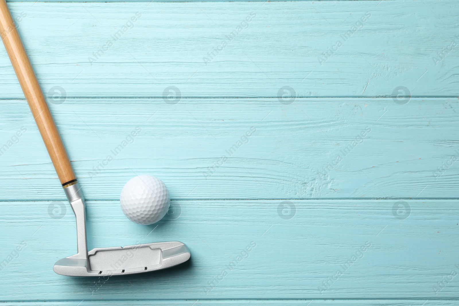 Photo of Golf club and ball on wooden background, flat lay with space for text