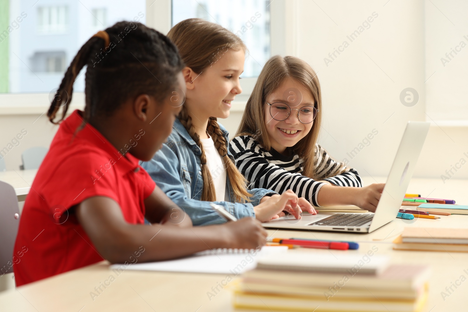 Photo of Cute children studying in classroom at school