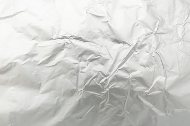 Photo of Crumpled silver foil as background, top view