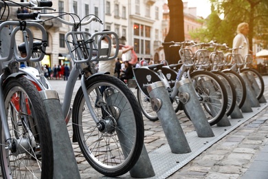 Photo of LVIV, UKRAINE - APRIL 27, 2019: Parking with bicycles for rent on Market Square