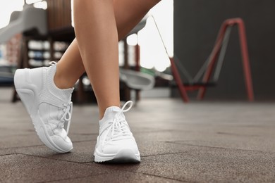 Photo of Woman wearing stylish sneakers outdoors, closeup. Space for text