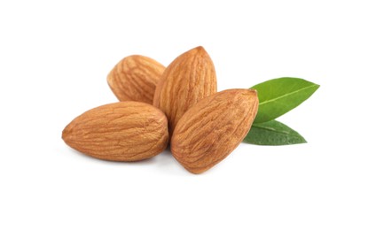 Photo of Organic almond nuts and green leaves on white background. Healthy snack