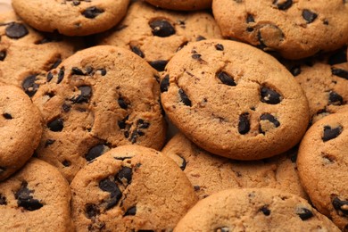 Photo of Delicious chocolate chip cookies as background, closeup