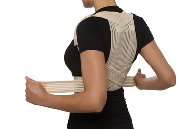 Photo of Closeup view of woman with orthopedic corset on white background