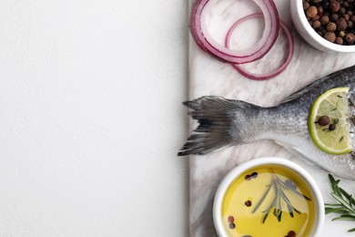 Photo of Fresh dorado fish and ingredients on white table, flat lay. Space for text