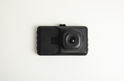 Photo of Modern car dashboard camera on white background, top view