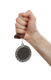 Photo of Man holding silver medal on white background, closeup. Space for design