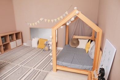 Photo of Stylish child room interior with comfortable floor bed