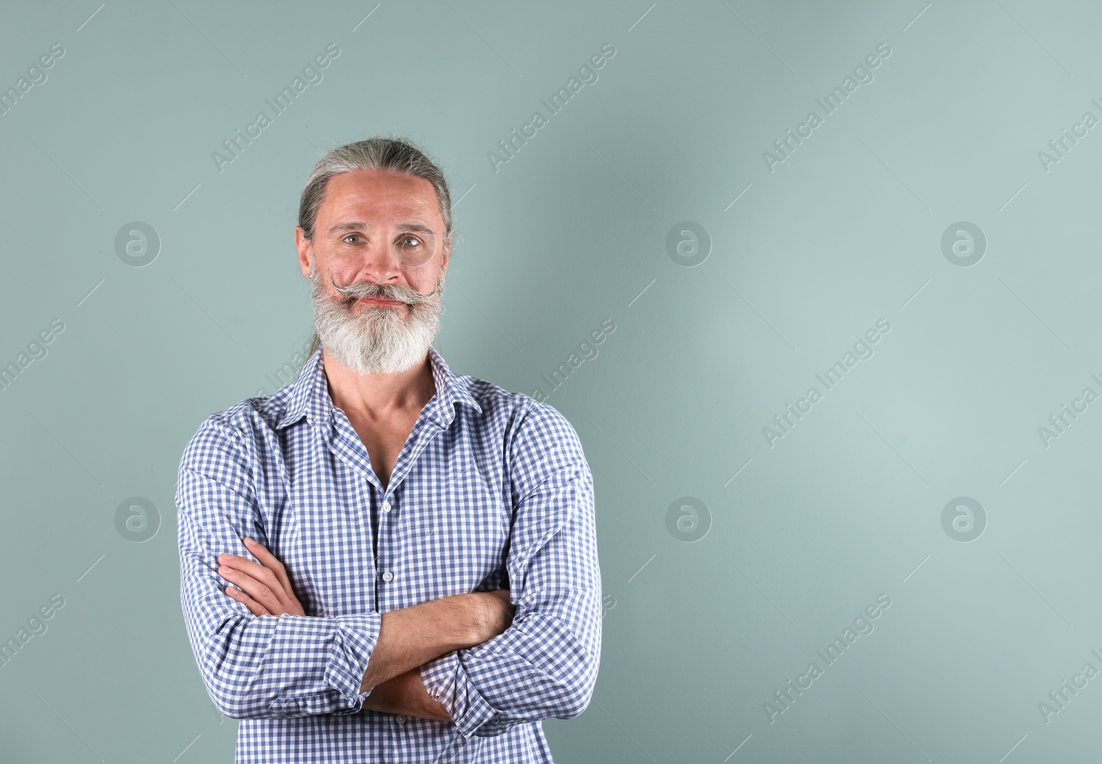 Photo of Portrait of handsome mature man on color background