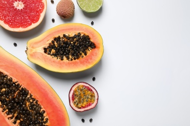 Photo of Fresh ripe papaya and other fruits on white background, top view