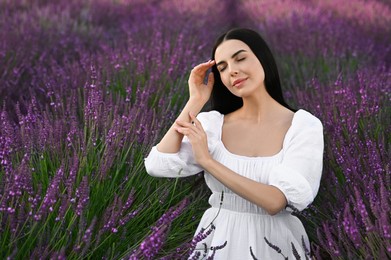 Photo of Portrait of beautiful young woman in lavender field