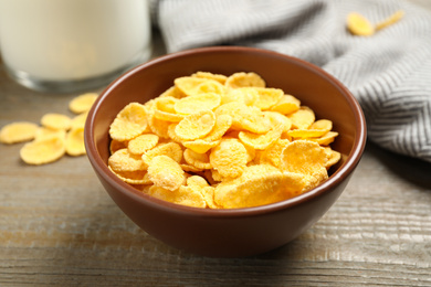 Photo of Tasty crispy corn flakes on wooden table