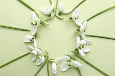 Photo of Frame of beautiful snowdrops on light background, flat lay. Space for text